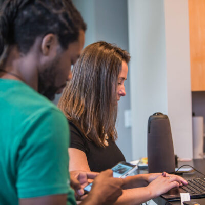 Two people evaluating a website on a laptop