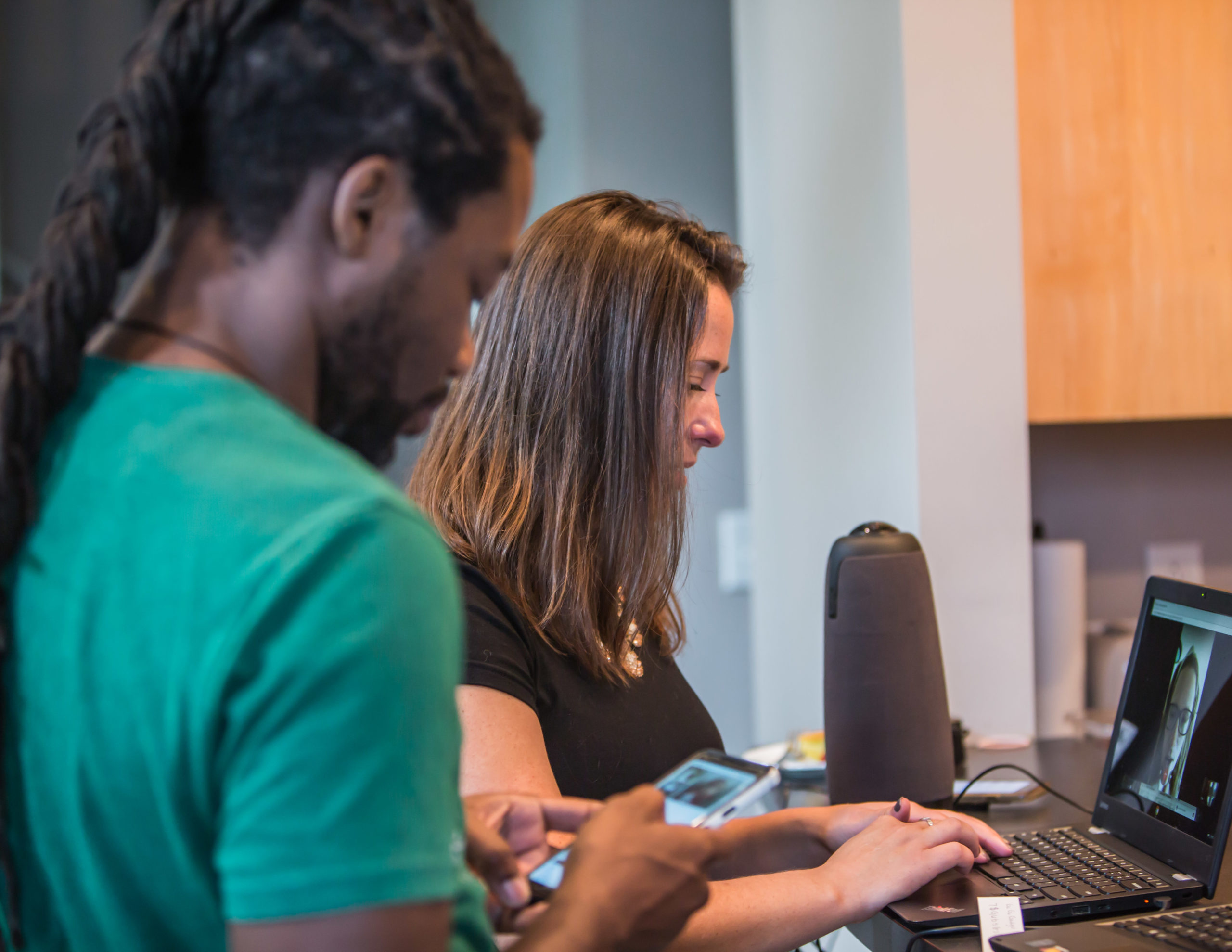 Two people evaluating a website on a laptop